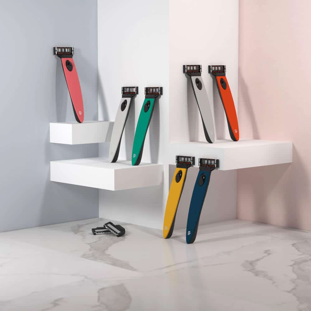 Colorful razors on white shelves