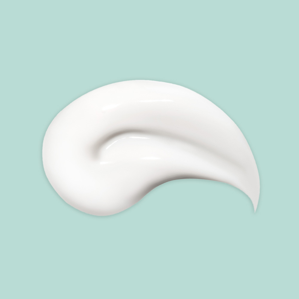 White cream smear on teal background.