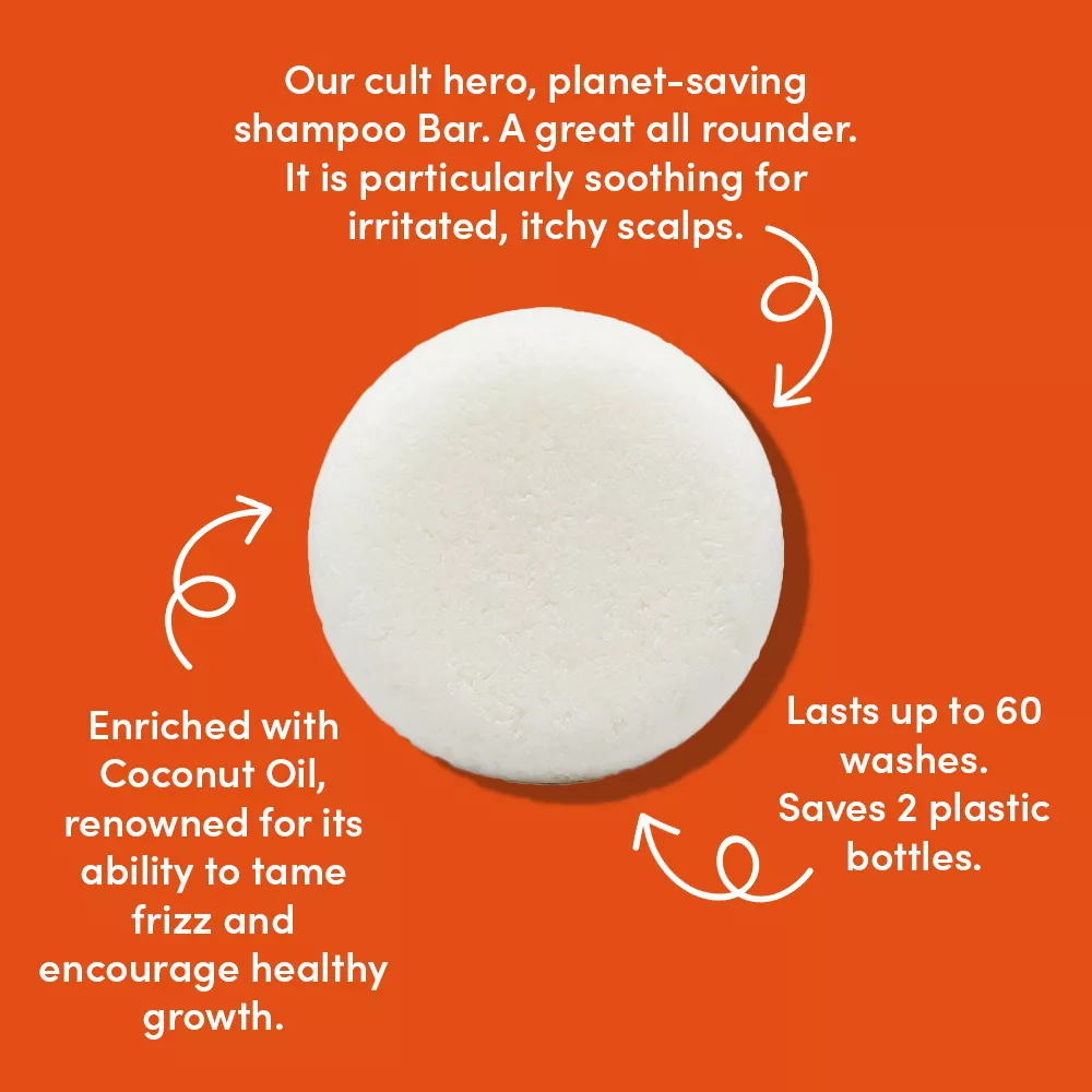 Round shampoo bar on orange background.