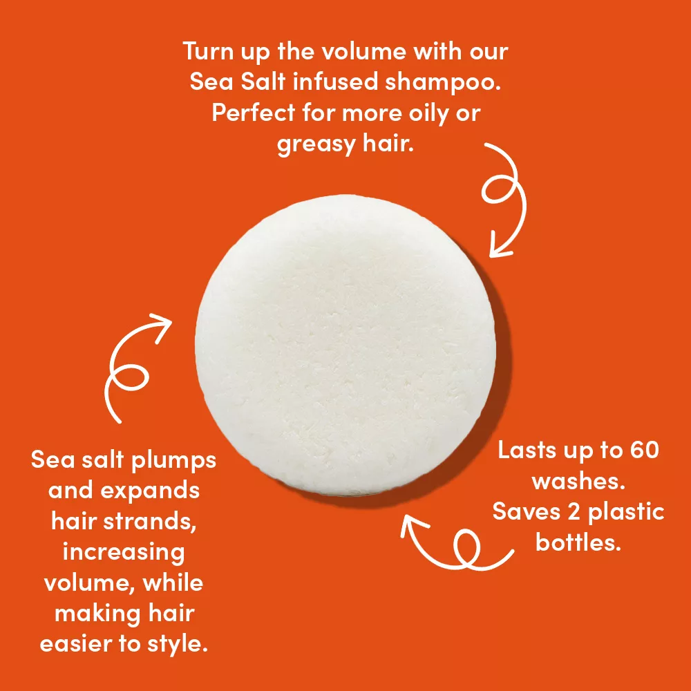 Round shampoo bar on orange background.