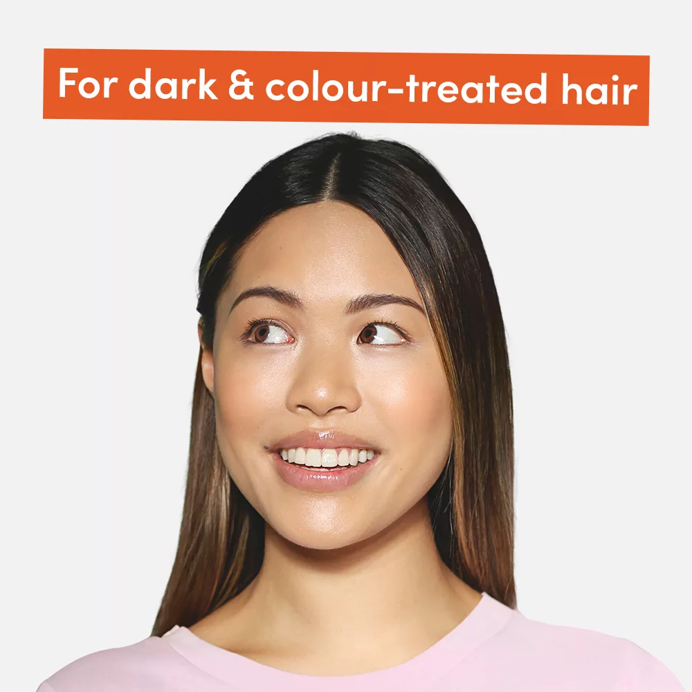 Smiling woman with dark hair.