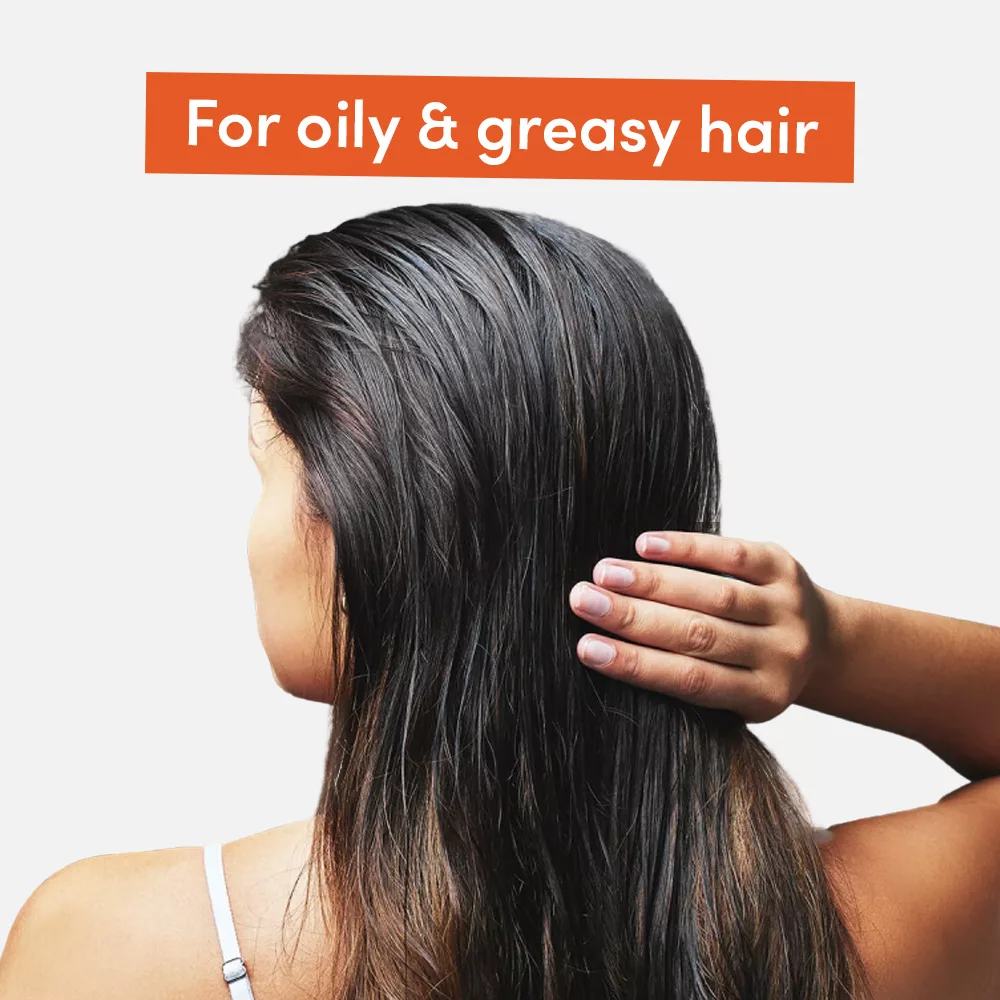 Person touching oily hair.