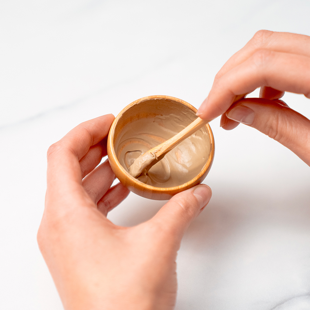 Hands mixing cream in a bowl