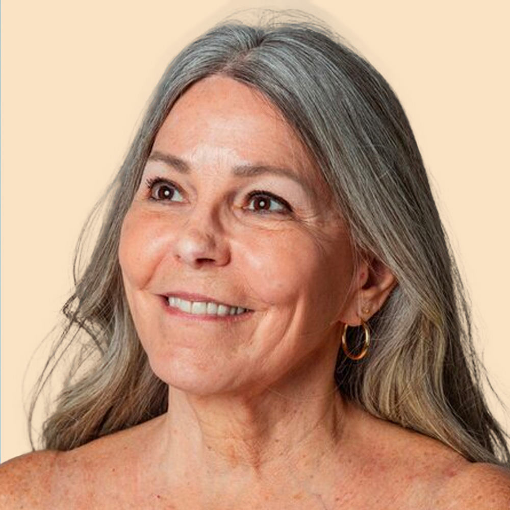 Smiling woman with long gray hair.