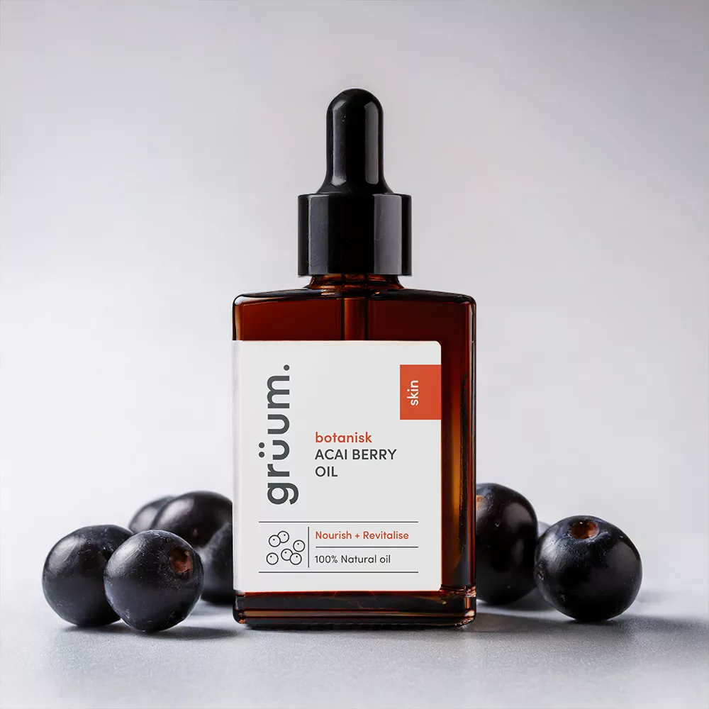 Acai berry oil bottle with berries.