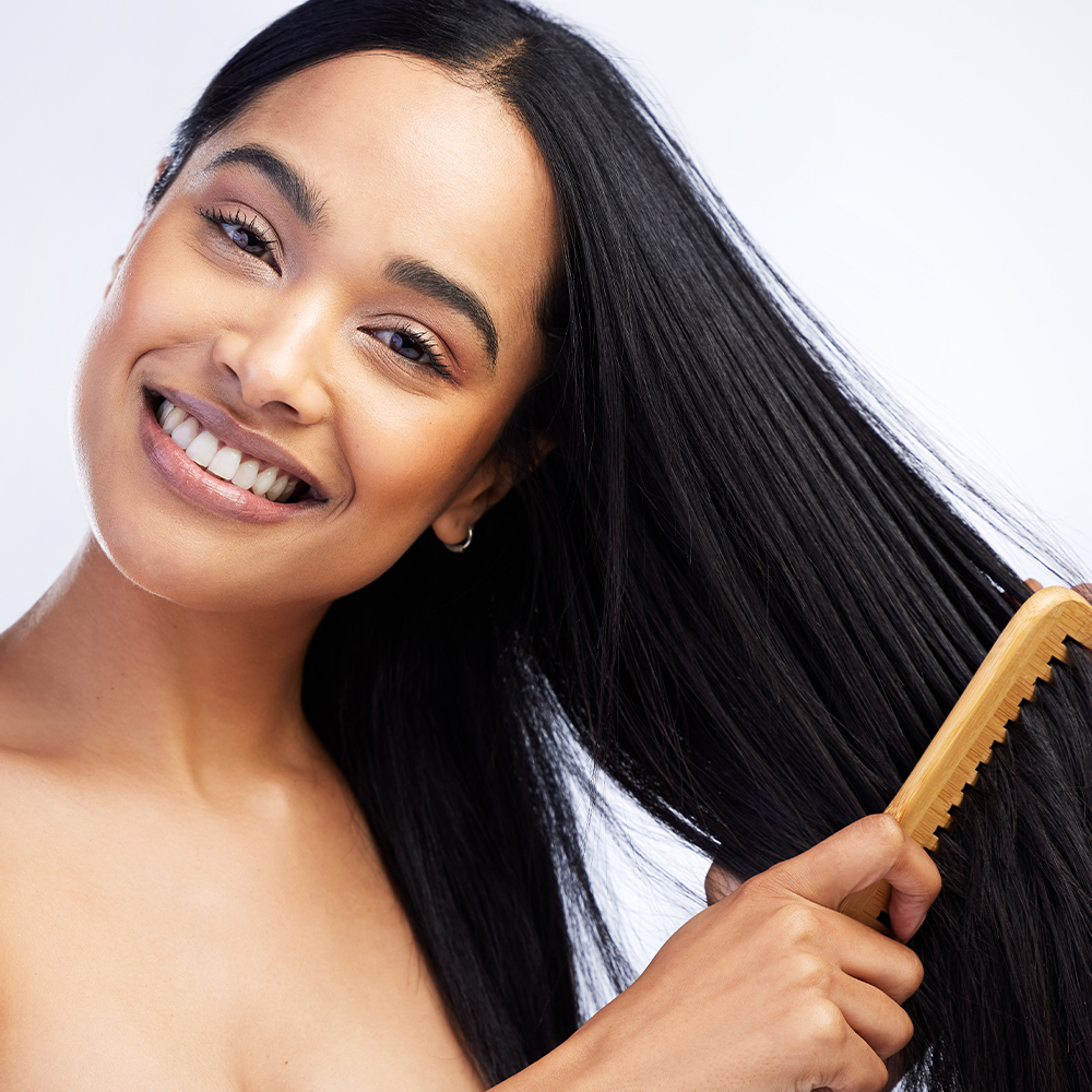 Woman combing her long black hair