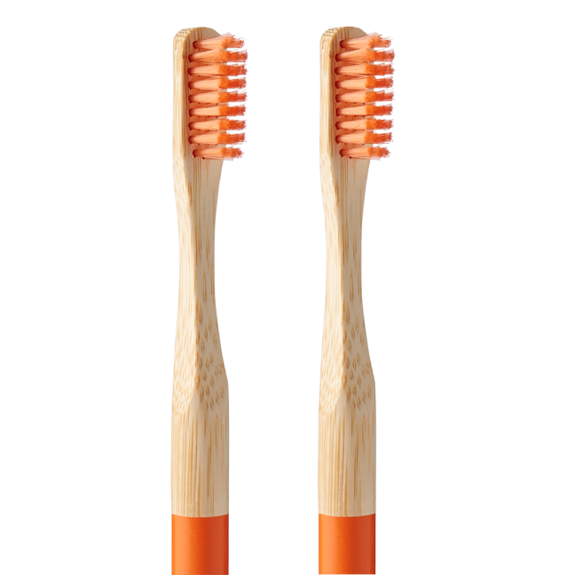Two bamboo toothbrushes with orange bristles.