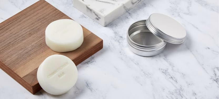 Two soap bars, open tin container.