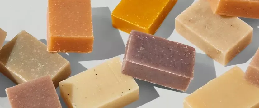 Various colored soap bars on white background.