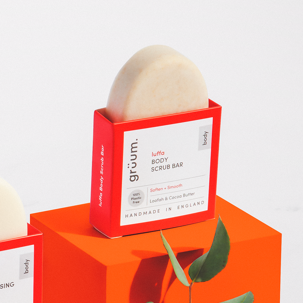 Luffa body scrub bar in red packaging.