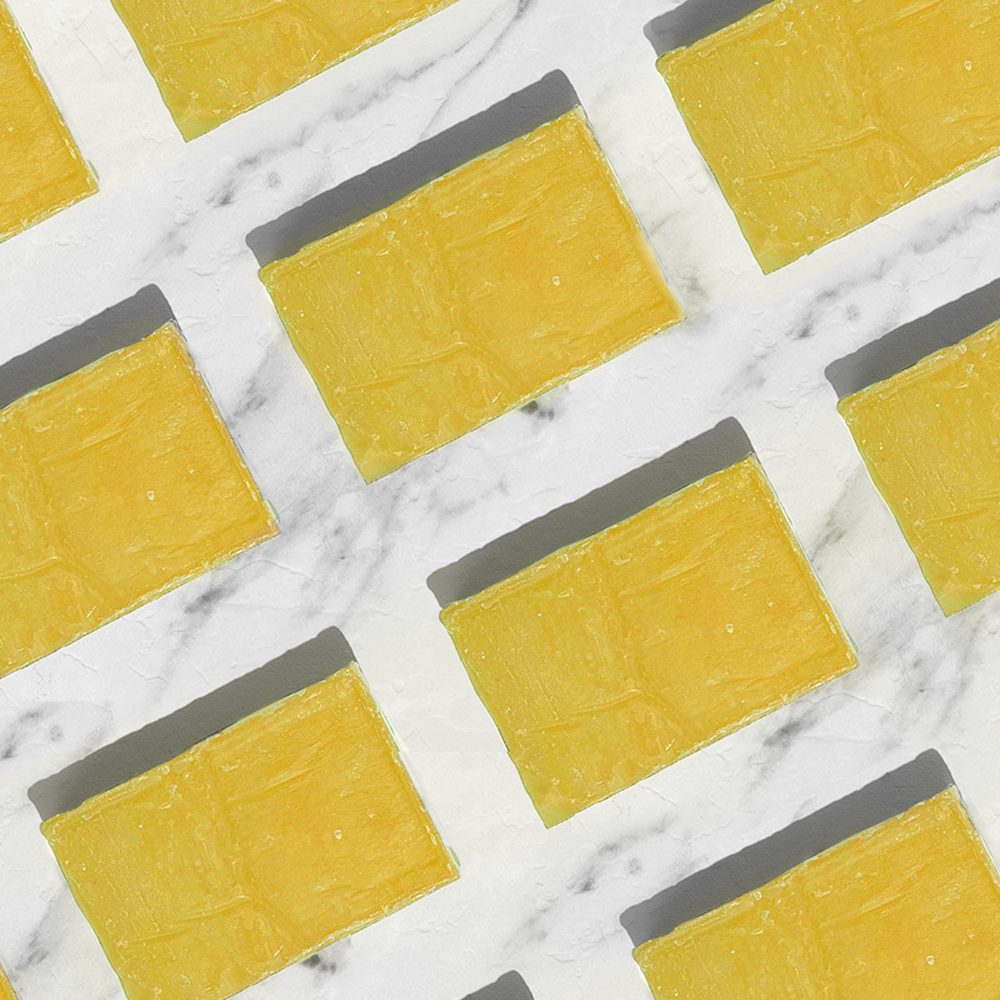 Yellow cheese slices on marble background