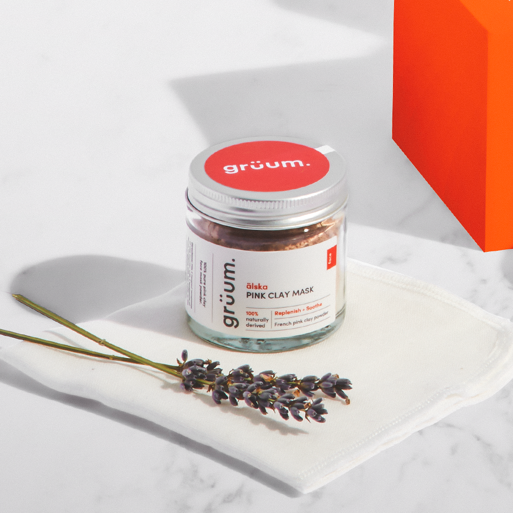 Clay mask jar on cloth with lavender