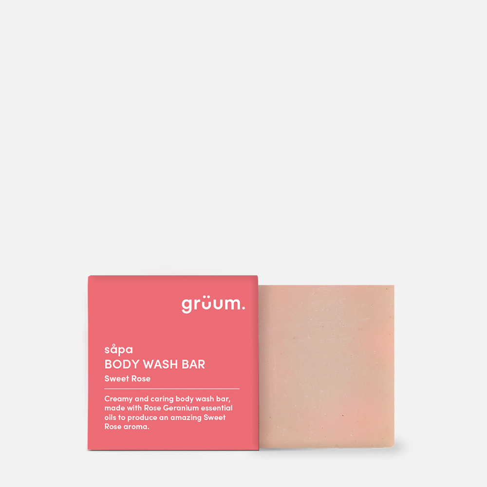 Pink body wash bar with packaging.