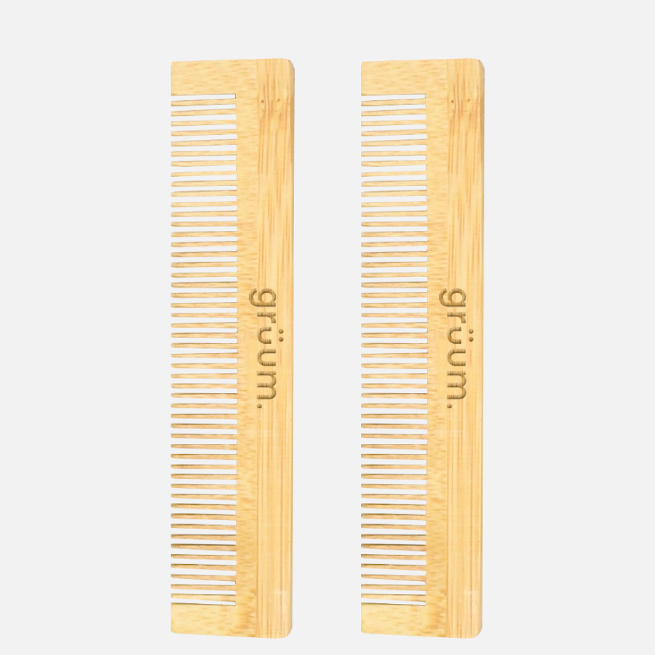 Two wooden combs standing upright
