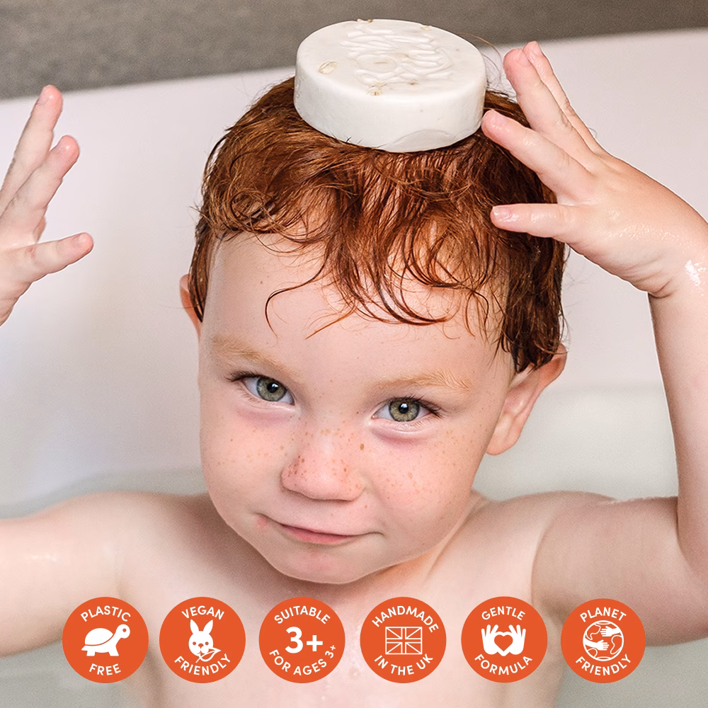 Child balancing soap on head