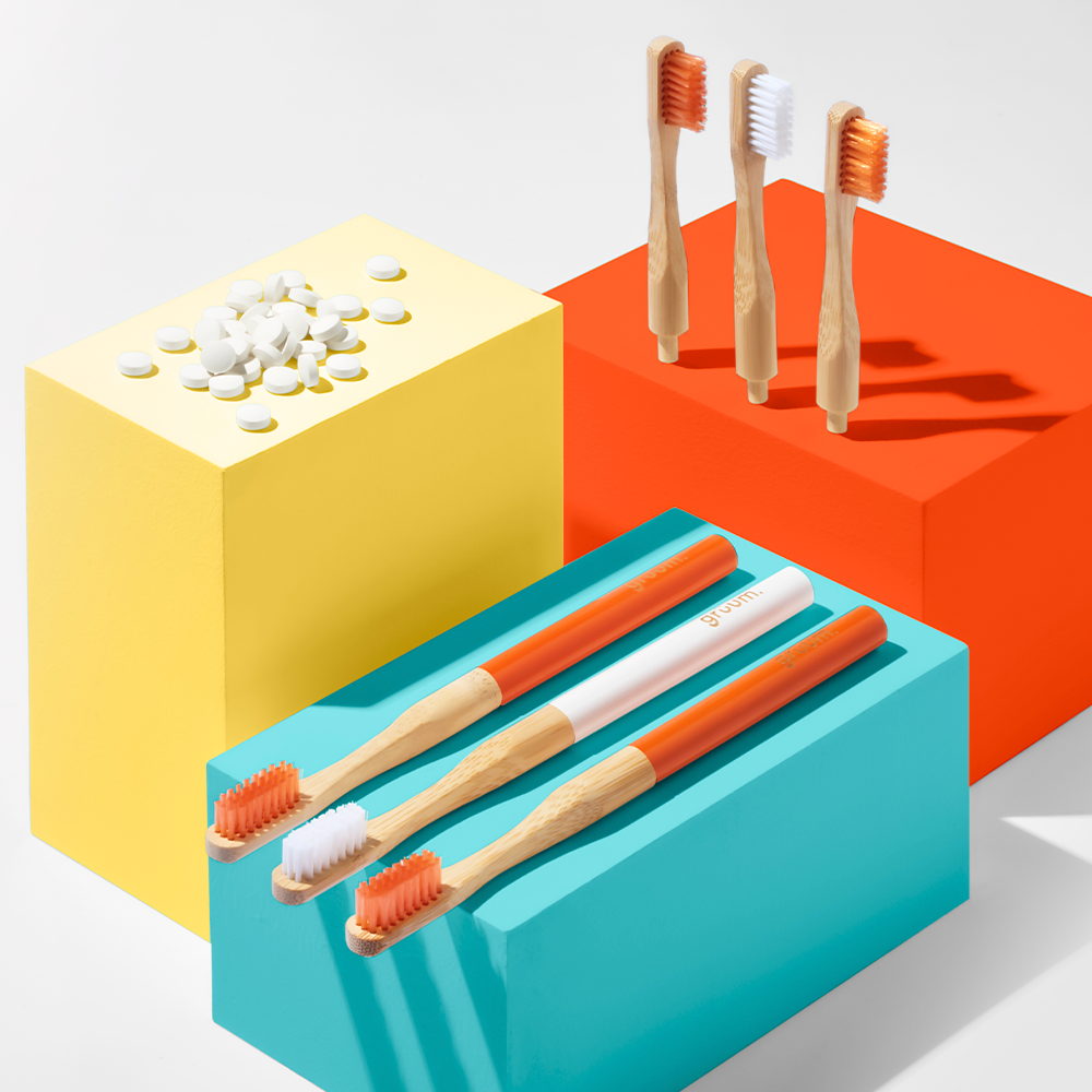 Colorful toothbrushes and tablets on blocks.