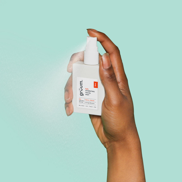 Hand holding facial mist bottle