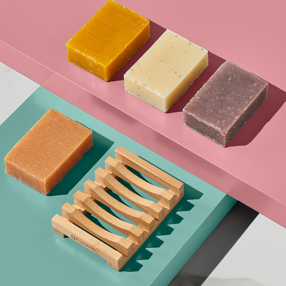 Four soap bars and wooden holder