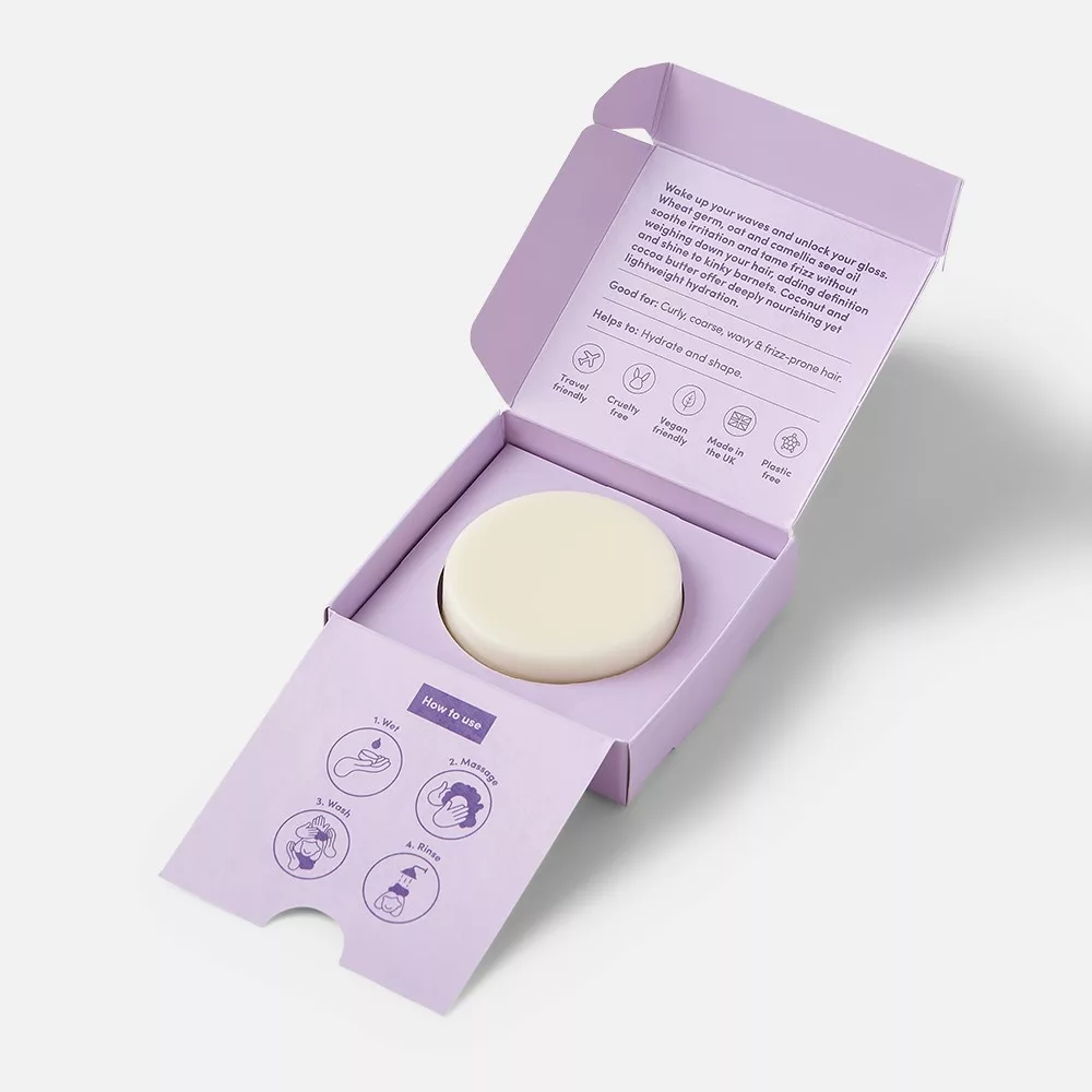 Purple box with a round soap inside.