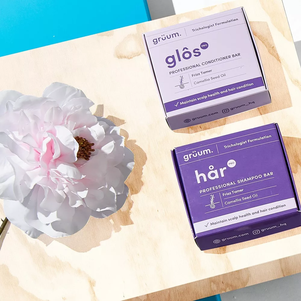 Two purple product boxes and a flower.