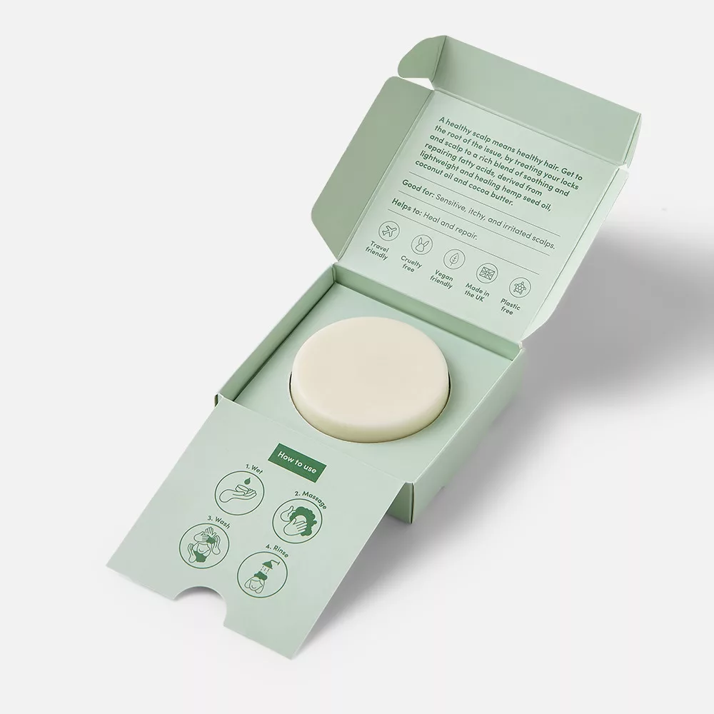 Open box with round soap bar.