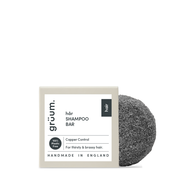 Black shampoo bar with packaging.