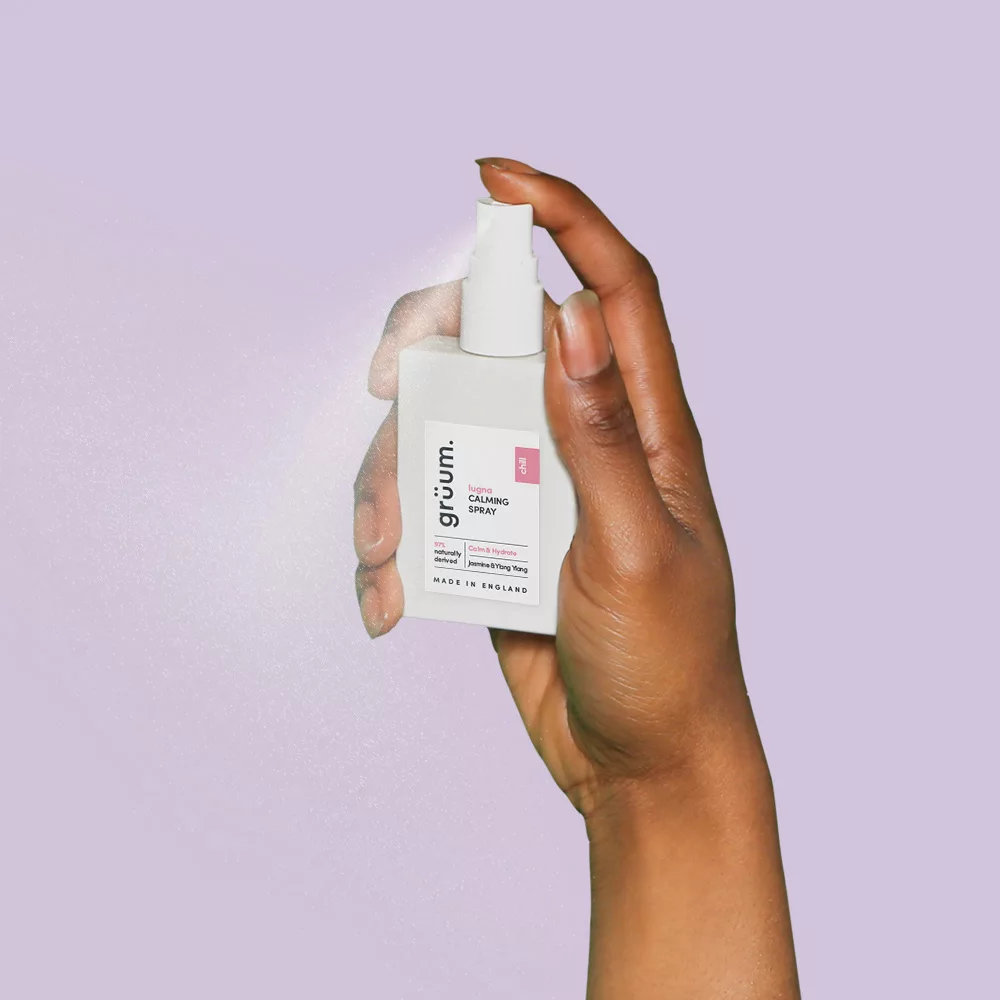 Hand holding calming spray bottle