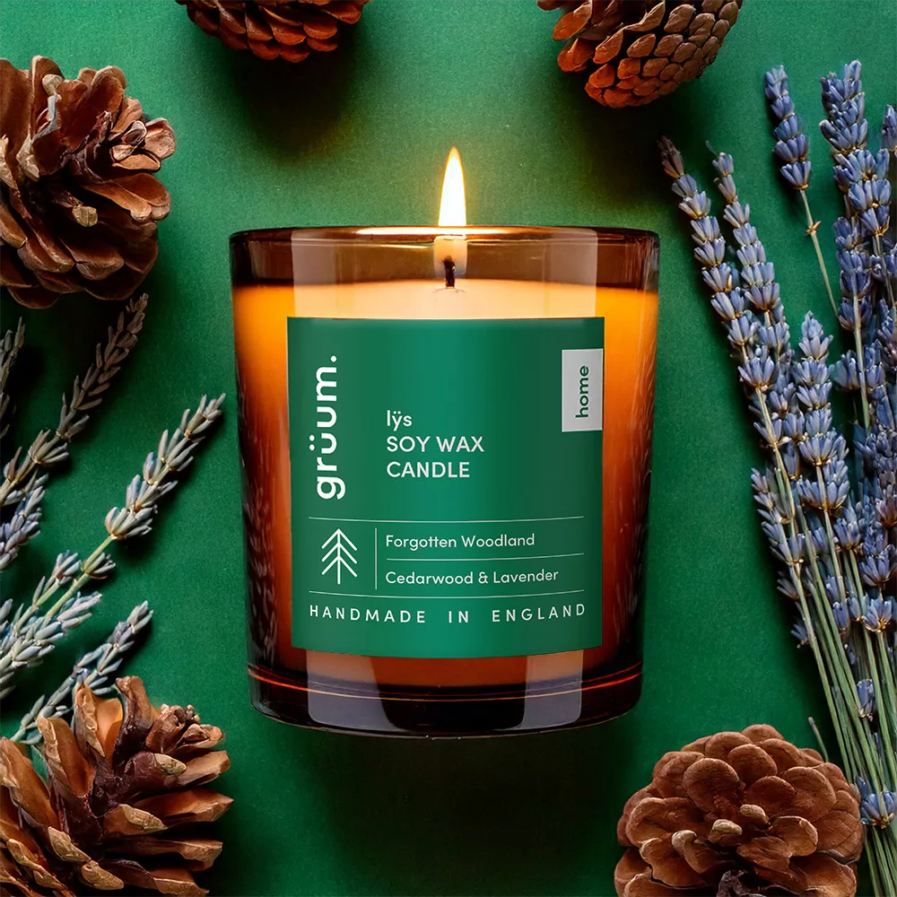 Candle surrounded by pine cones and lavender