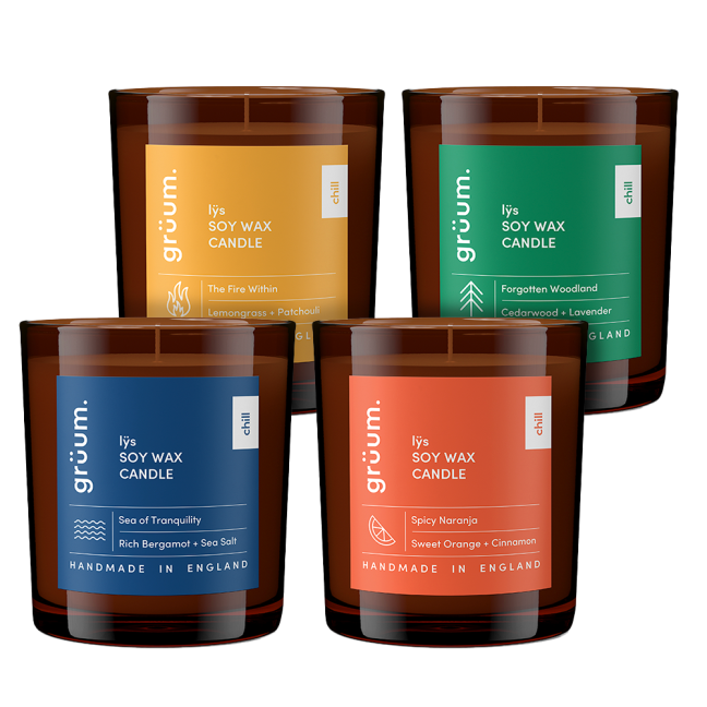 Four soy wax candles with colorful labels.
