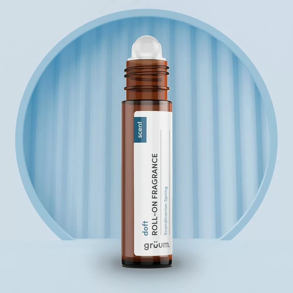 Roll-on fragrance bottle on blue background.