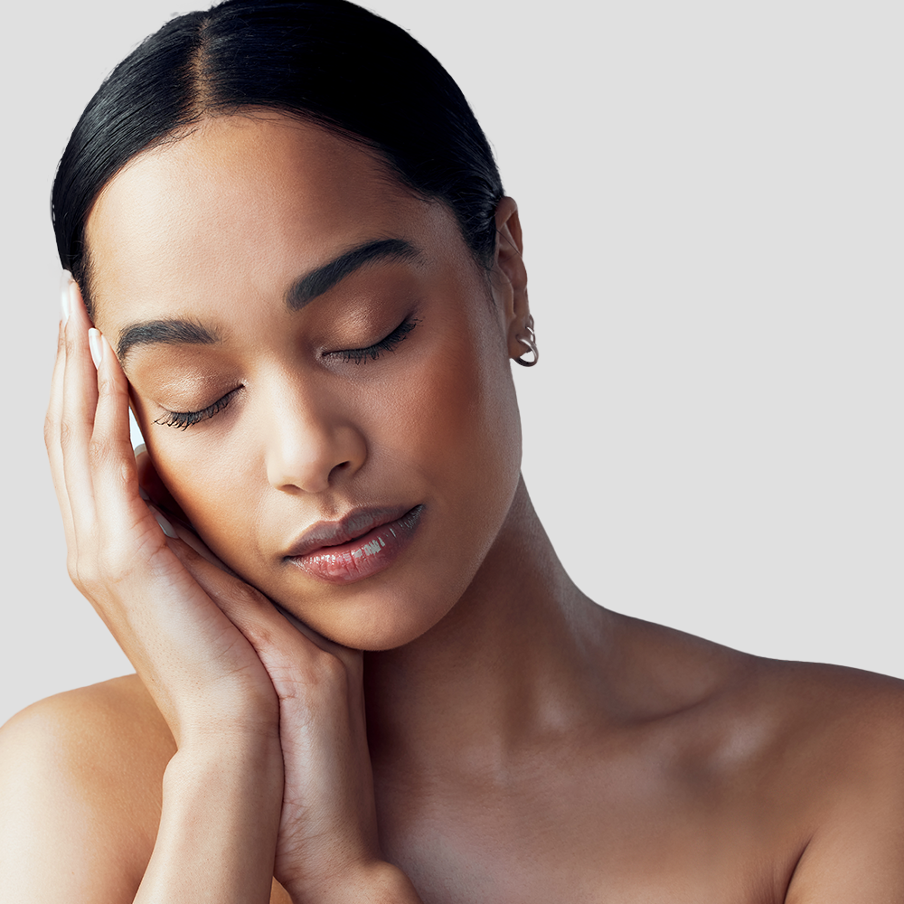 Woman with closed eyes and hands on face.