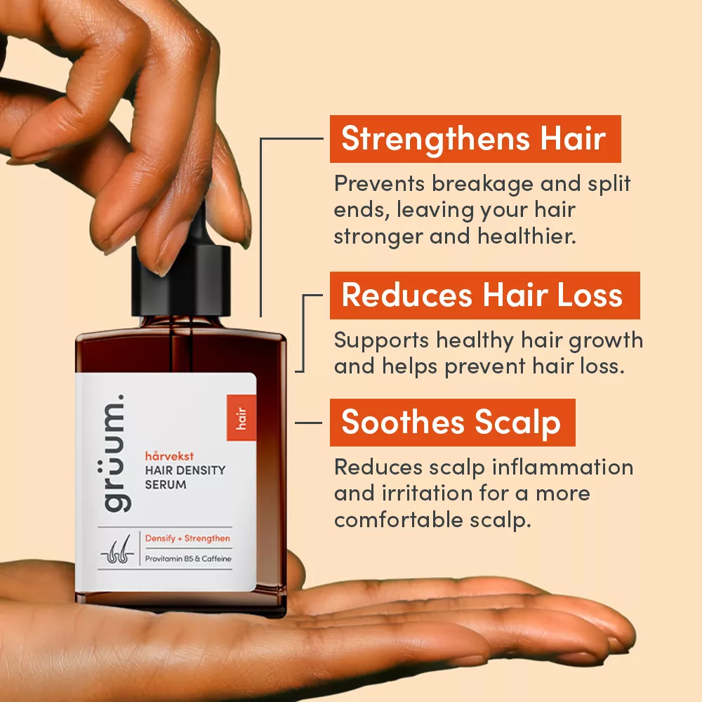 Hand holding hair density serum bottle.