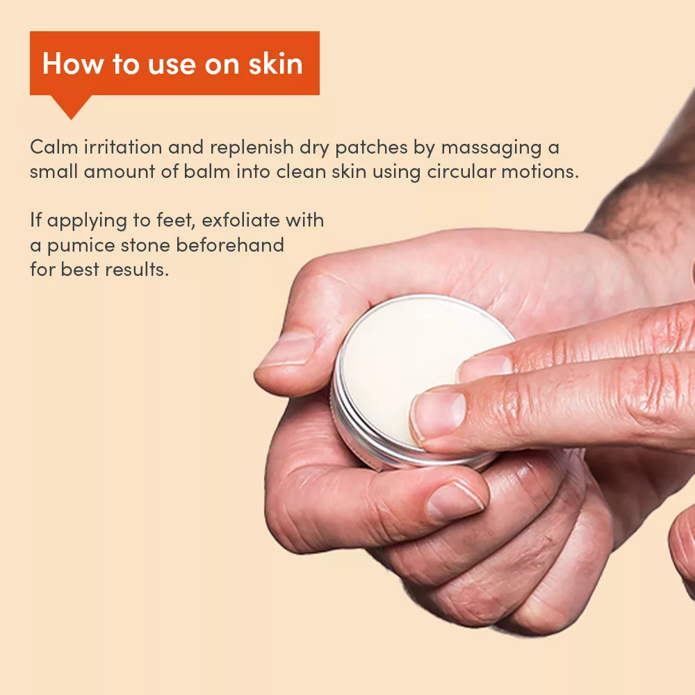 Hands applying balm from small tin.