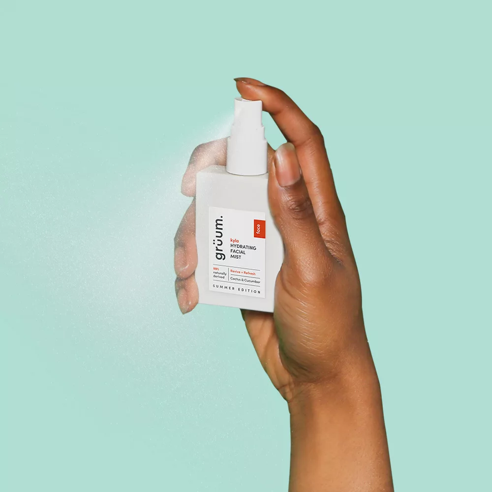 Hand holding facial mist bottle