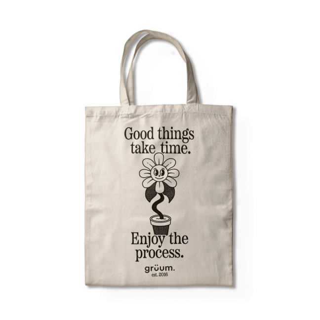 Tote bag with motivational quote and flower design.