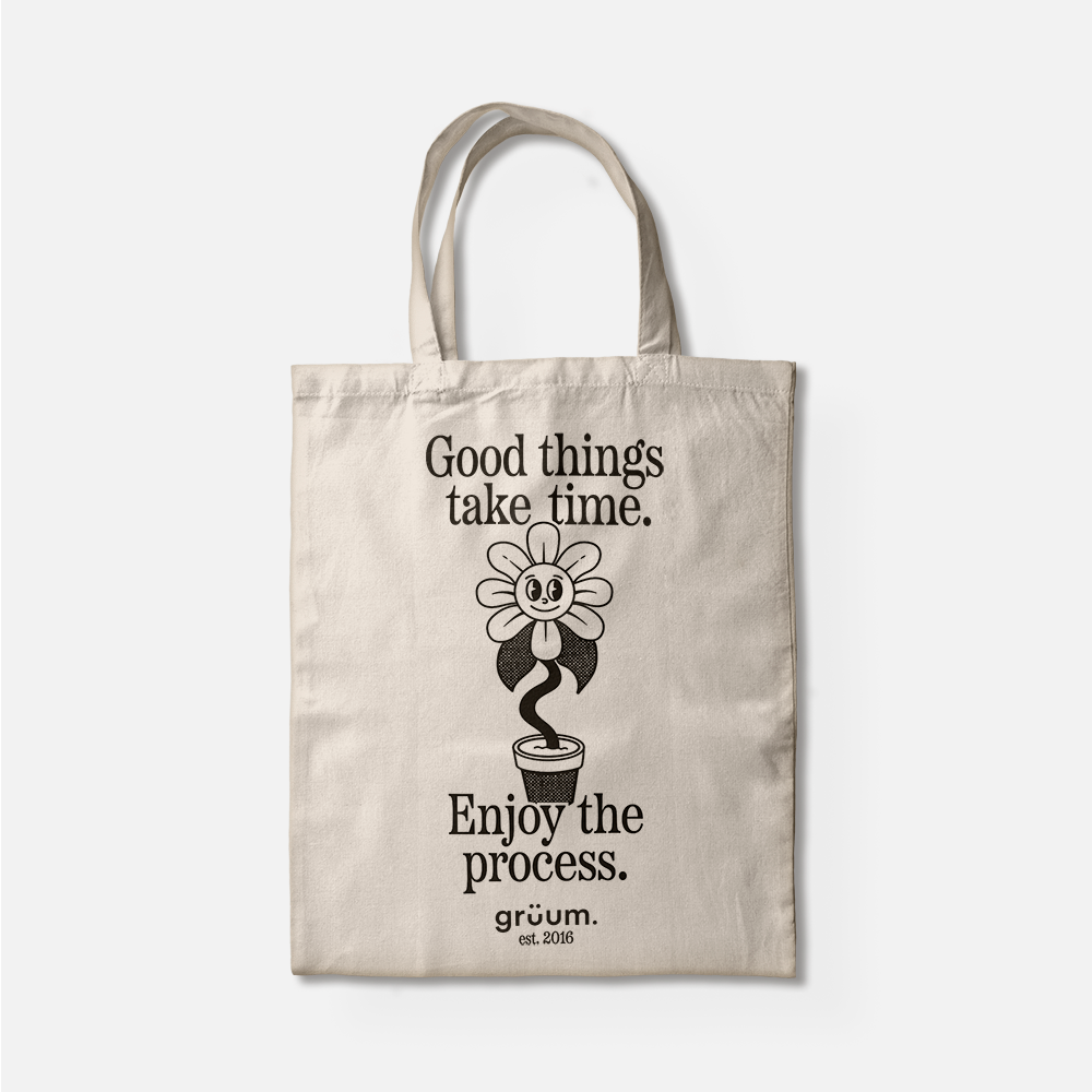 Tote bag with motivational text and flower design.