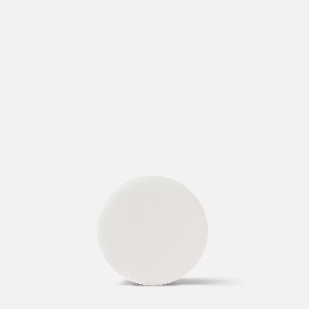 White round object on white background.