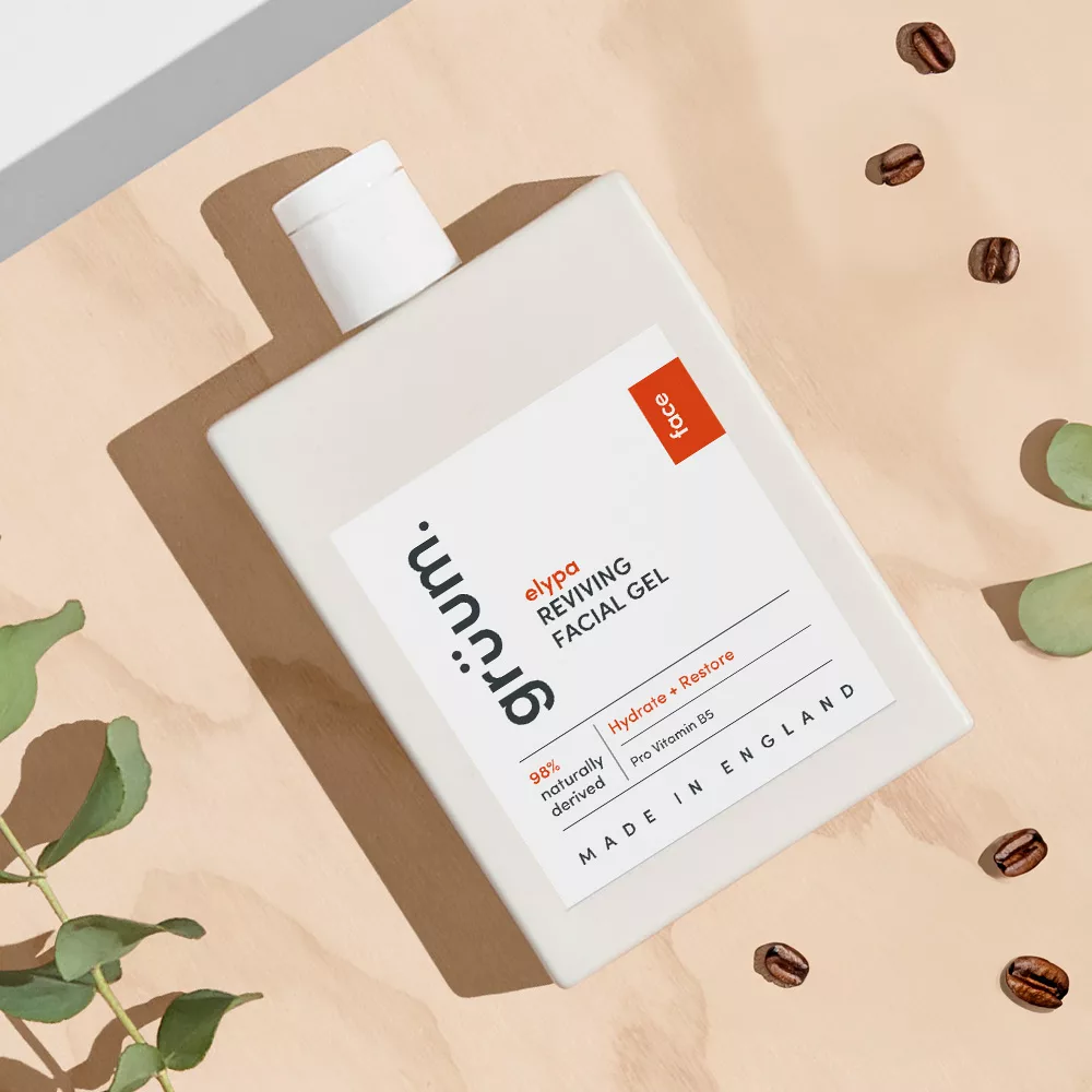 Facial gel bottle on table with leaves.