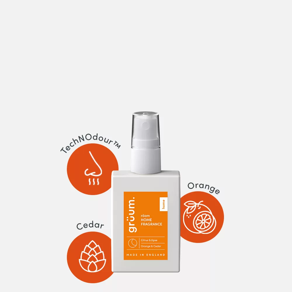 Fragrance bottle with orange and cedar graphics.