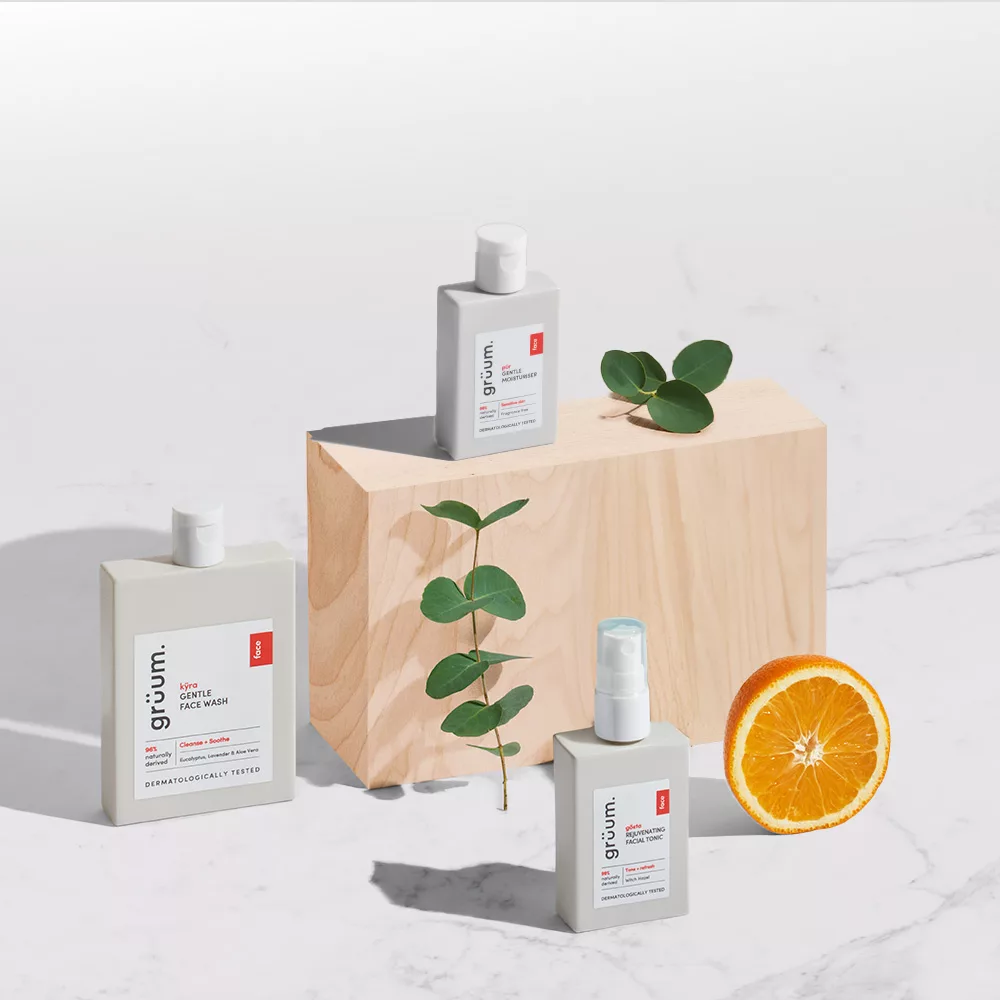 Skincare bottles with orange and leaves