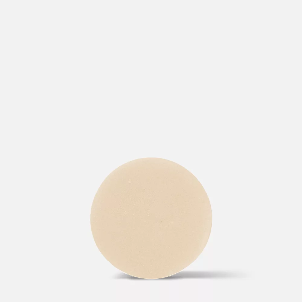 Beige circular object on white background.