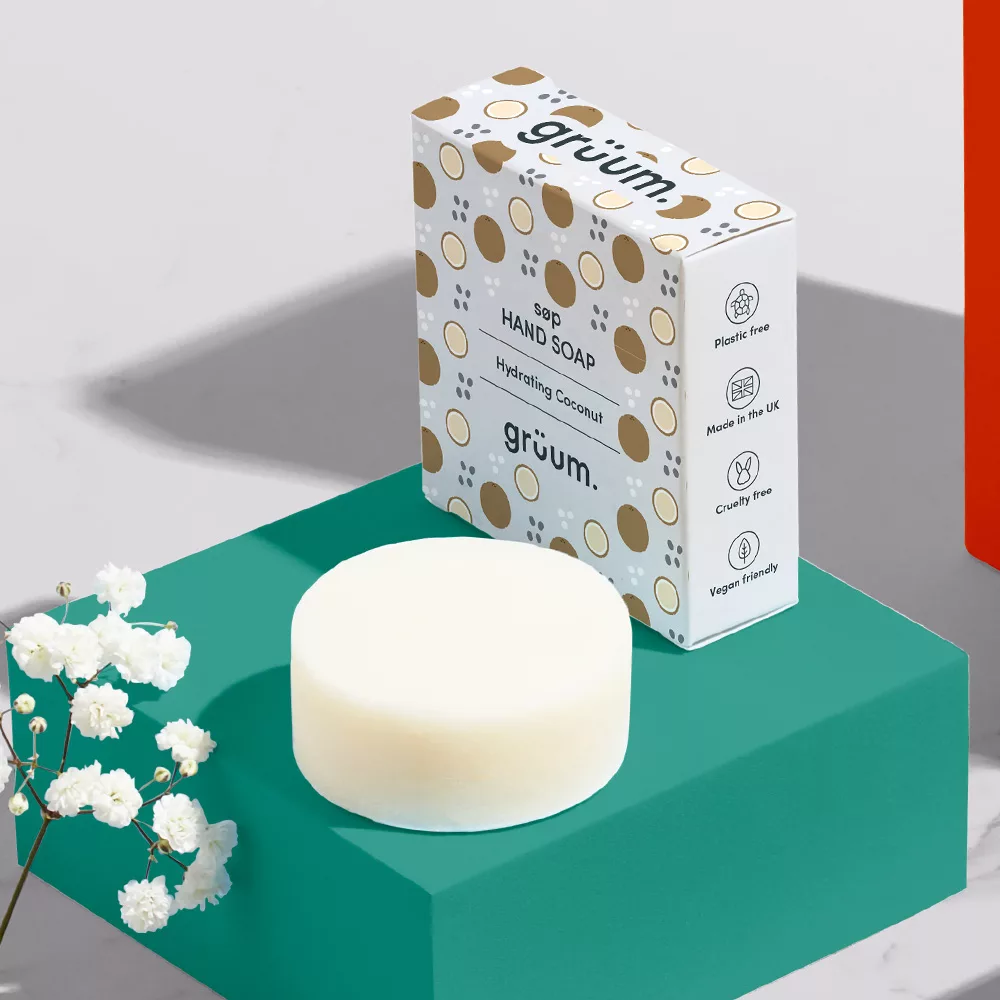 Coconut hand soap with box and flowers.