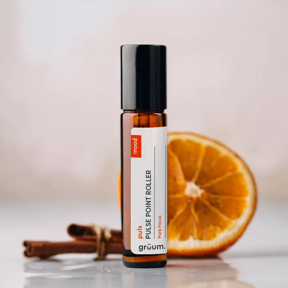 Roller bottle with orange slice backdrop.