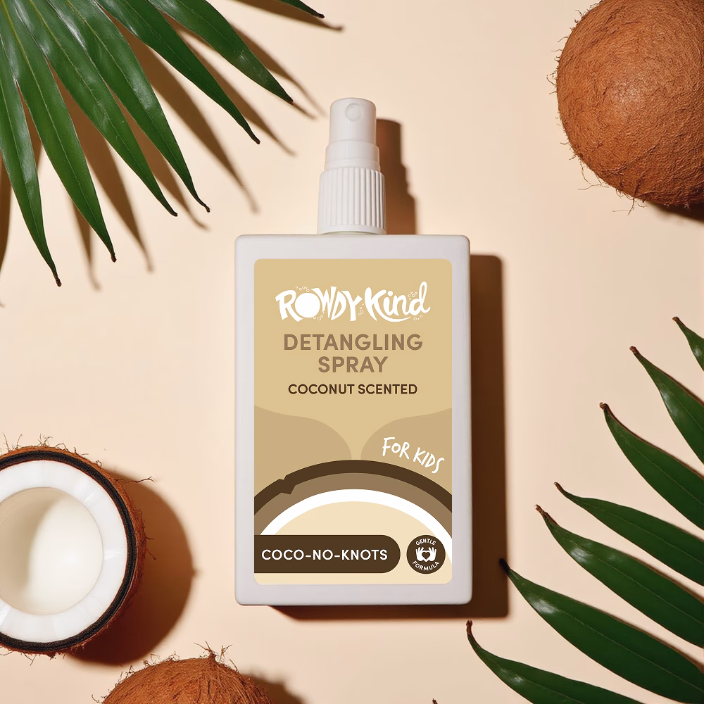 Coconut scented detangling spray with coconuts and leaves.