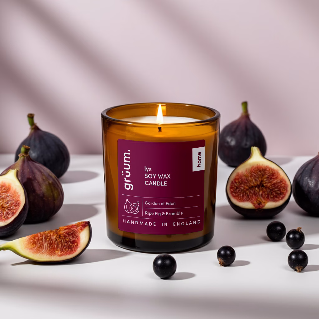 Lit soy wax candle with figs and berries.