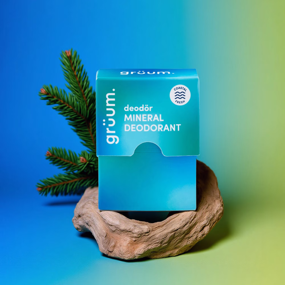 Mineral deodorant on wood with pine branch.