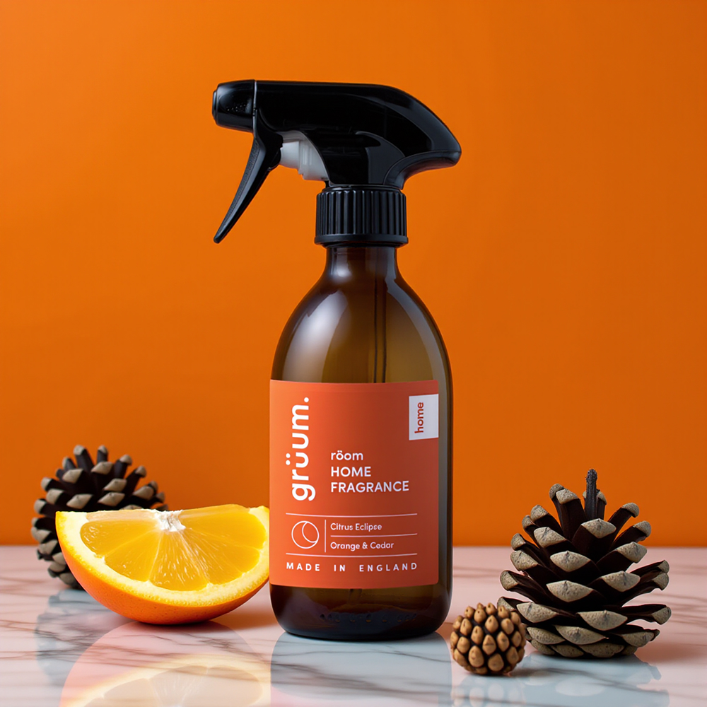 Fragrance bottle with orange and pinecones.