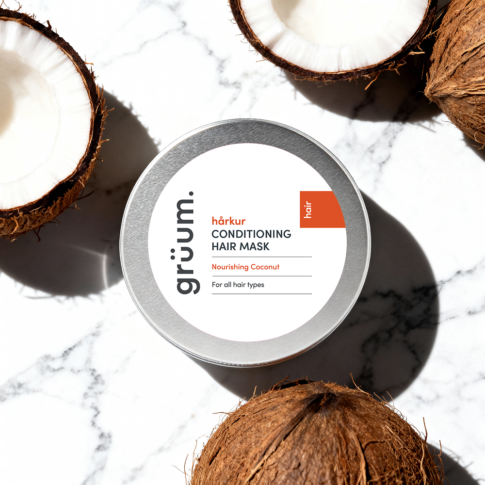 Hair mask tin surrounded by coconuts