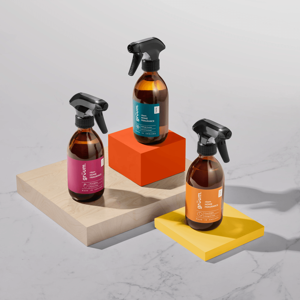 Three spray bottles on colored blocks.