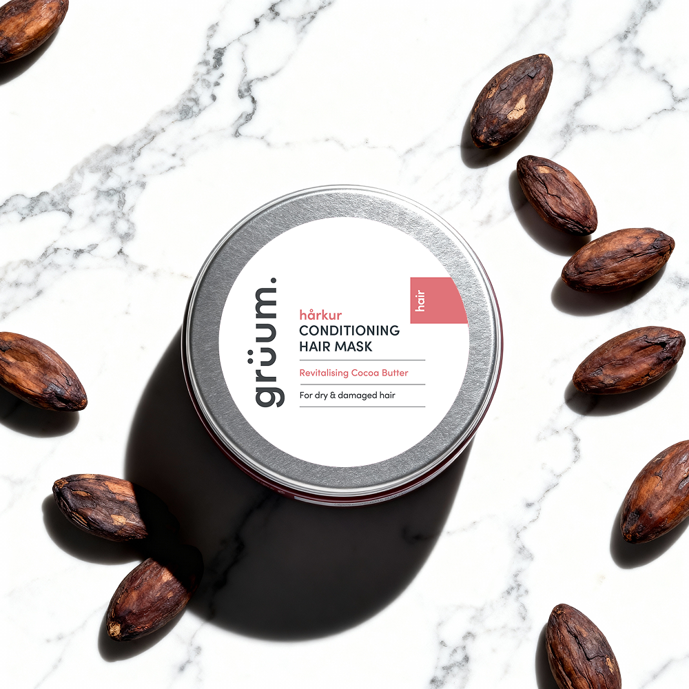 Hair mask tin with cocoa beans.